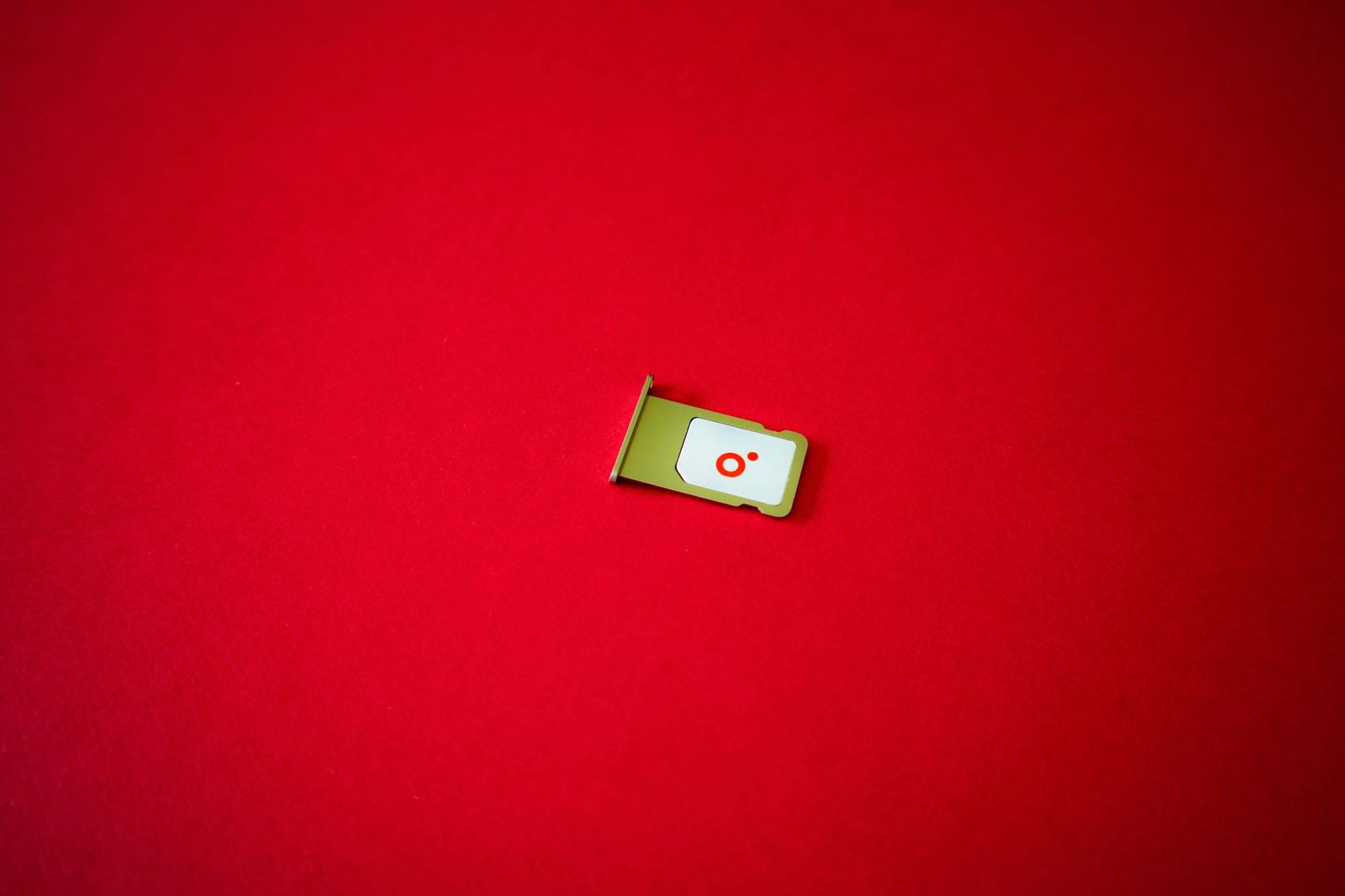 SIM card tray on a red background, representing UK mobile number ranges